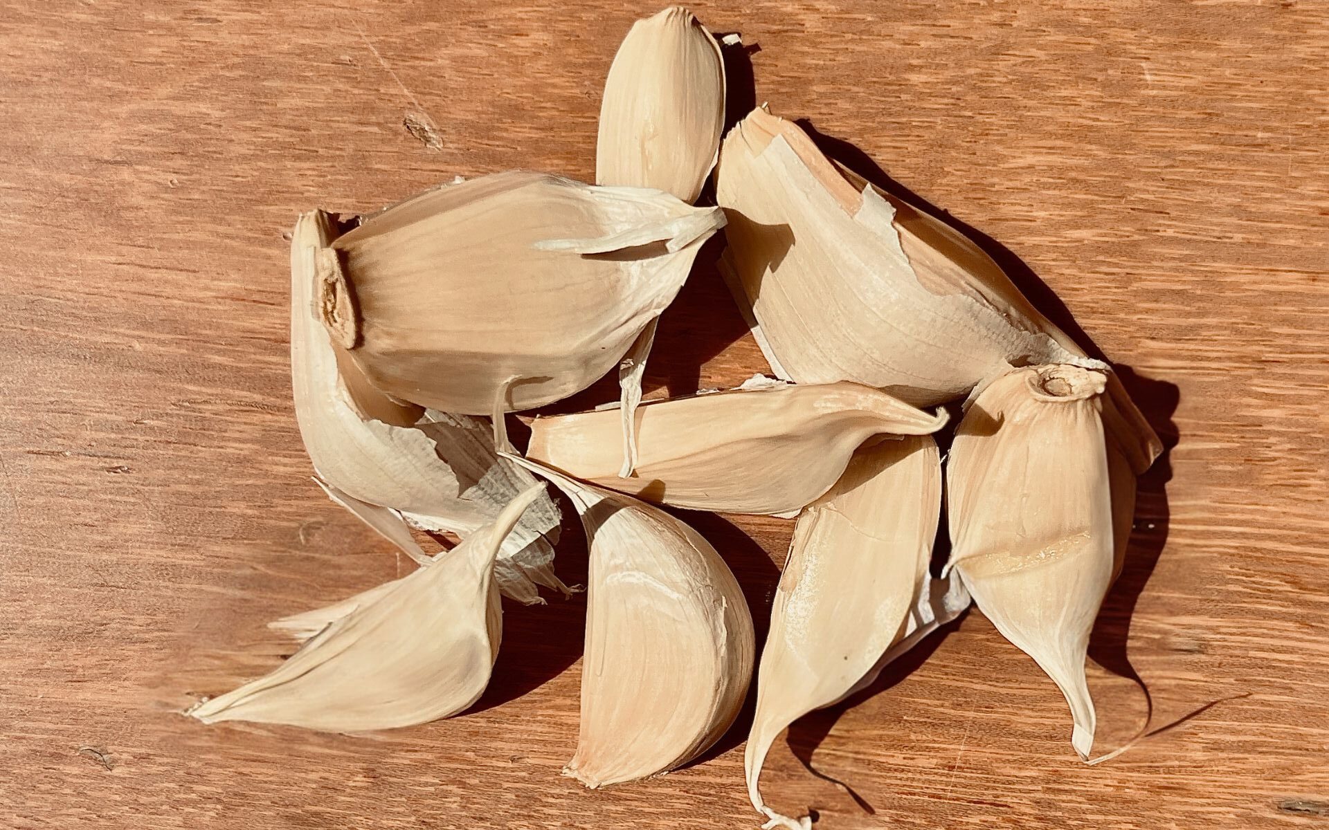 8 pieces of garlic cloves on a brown table