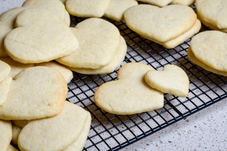 Heat shaped vanilla sugar cookies on a cooling rack